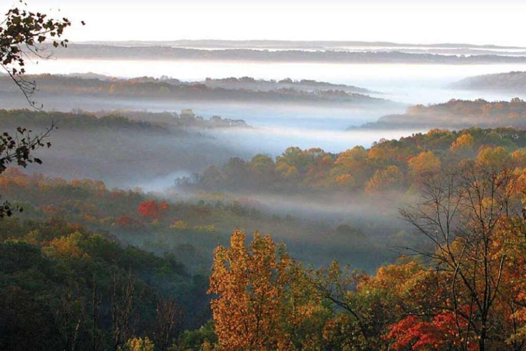 fog drifts over hills of Brown County in autumn