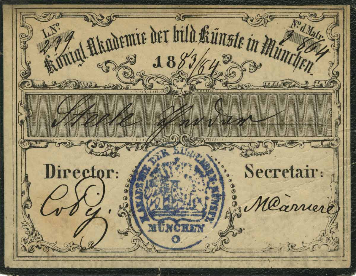 a weather old student identification card with blue print and black ink handwriting
